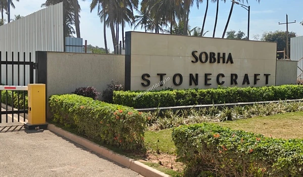 Close up view of the Sobha Stonecraft signage with landscaped greenery at the granite polishing unit of Sobha World City