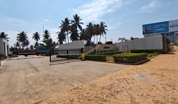 Wide view of the Sobha Stonecraft granite polishing unit entrance showcasing the main gate and surrounding infrastructure at Sobha World City