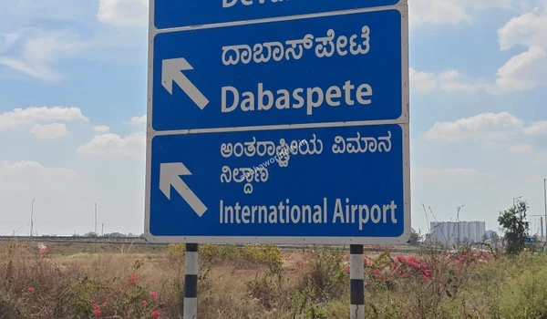 Strategic road connectivity indicated by prominent blue highway signs, offering Sobha World City residents quick and easy access to key destinations