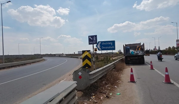 Heavy vehicles navigating the prime highway corridor near the NE-7 entry point, establishing the strategic transit advantage of living at Sobha World City.