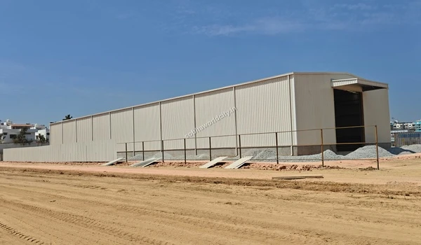 Close perspective of the long temporary site shed built to support construction operations at Sobha World City