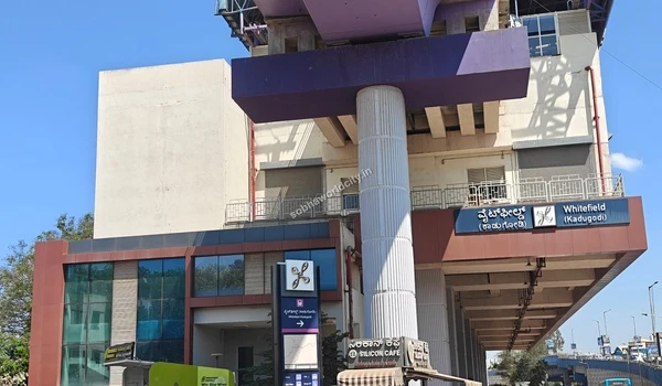 Direct view under the massive purple transit viaduct at Whitefield Kadugodi station connecting to Sobha World City