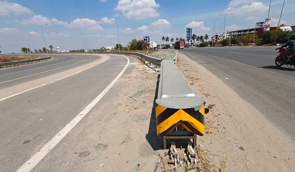 Heavy transport and daily vehicles utilizing the straight highway route to Kolar, passing the Sobha World City exit.