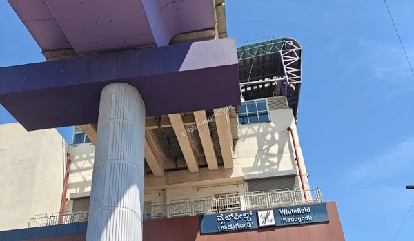 Close up view of the massive purple metro pillar and transit structure at Whitefield Kadugodi station near Sobha World City